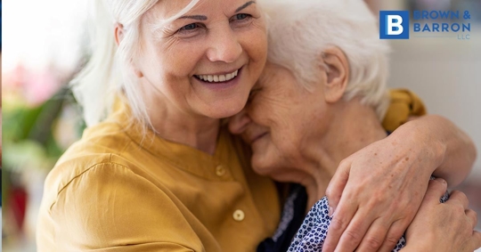 A woman hugs her elderly mother