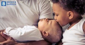 Little boy kissing a baby