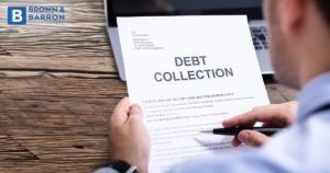 Man looking at "debt collection" paper