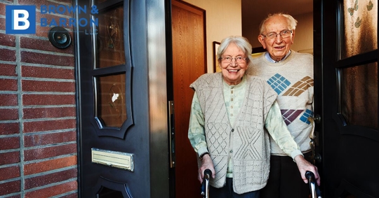 Older couple walking out the door