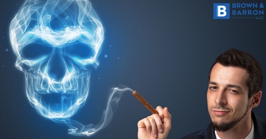 Man blows cigar smoke into a cloud resembling a skull