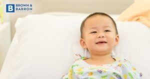 Baby laying on a hospital bed
