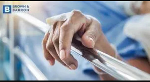 Hand on hospital bed