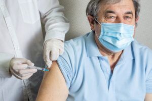Older man receiving a vaccine