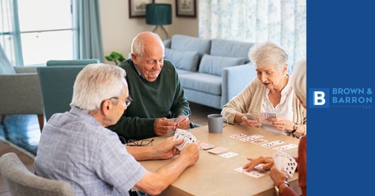 elderly individuals playing cards at a table