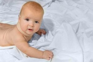 Baby on white sheets