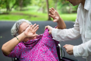 Person putting their hands on elderly woman