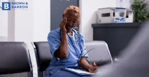 Nurse rubbing her head