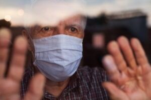 Older man looking through the window