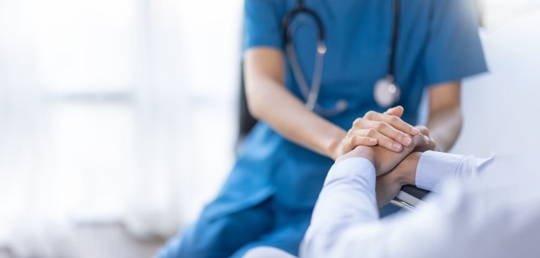 Cropped shot of a female nurse hold her senior patient's hand